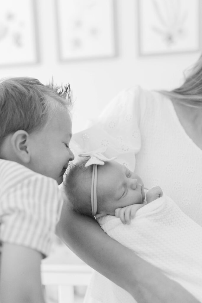 toddler and newborn in the nursery in a Salt Lake City newborn session captured by Salt Lake City newborn photographer