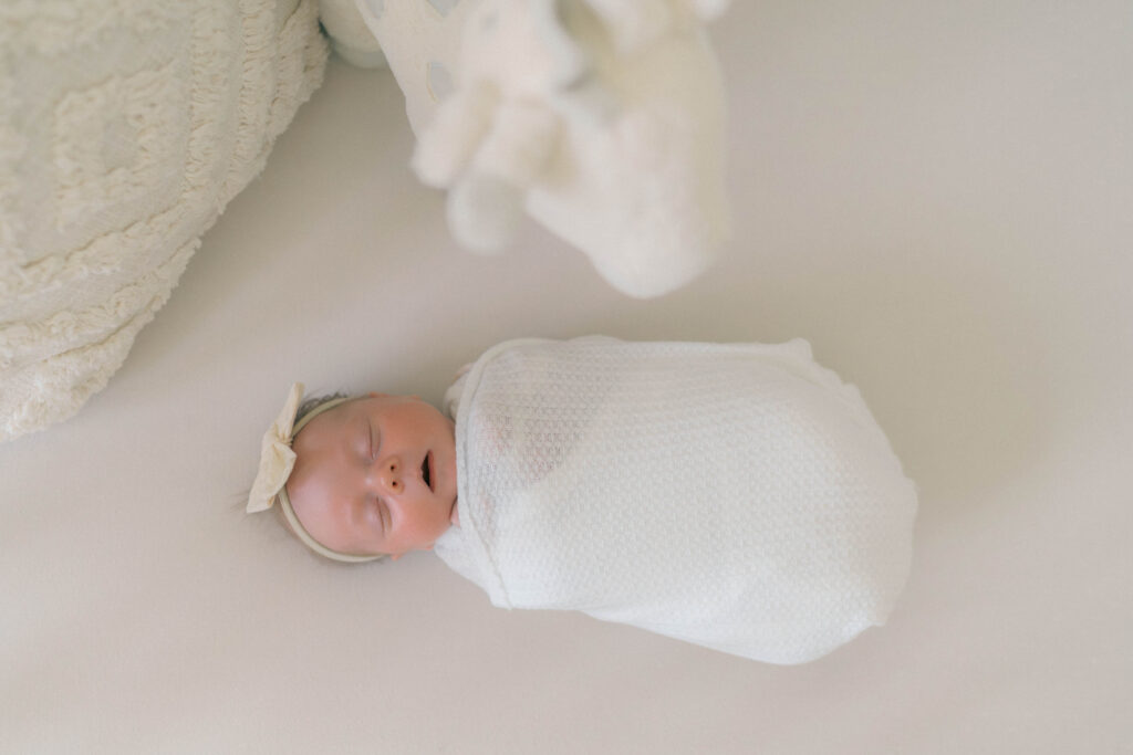 newborn in crib in a beautiful nursery designed. Captured by newborn photographer utah
