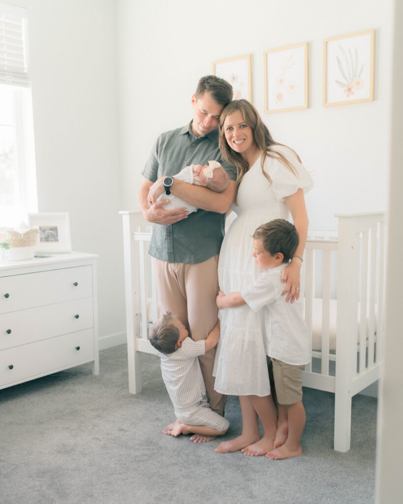 parents at home during newborn session in the nursery captured by newborn photographer in utah