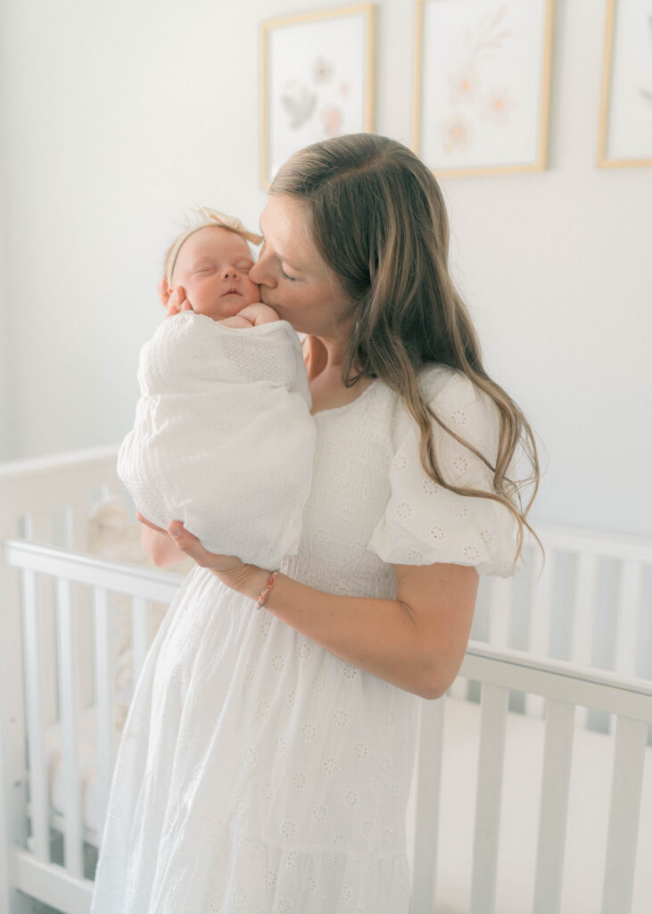 mom holding newborn baby at home newborn session in Salt Lake City, utah. Captured by utah newborn photographer