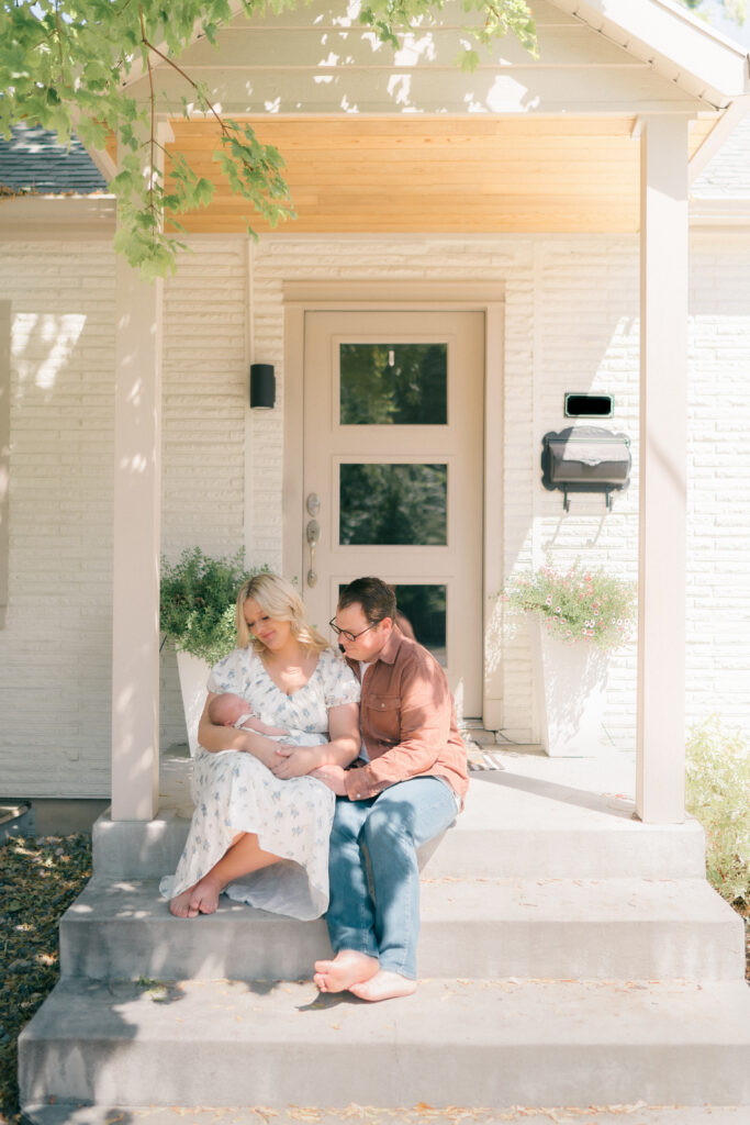 In-home newborn session South Holladay pines ct -baby with mom and dad in natural light home.